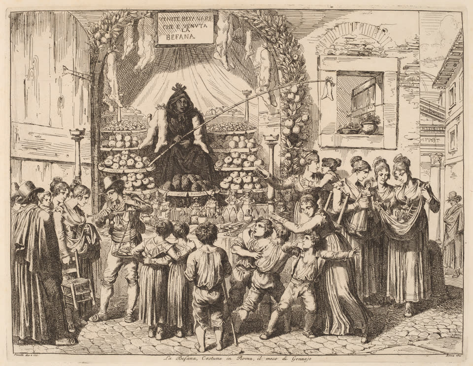 An etching of a Befana stall in a Roman street, published in 1821. Under a hand-lettered sign reading VENITE BEFANARI CHE E VENUTA LA BEFANA, a seated figure of the Befana is enthroned on a draped platform above tiers of fruit and sweets banked up on round trays, with a garland of fruit hanging down the pillar beside her. A man leans in from the right with a long cane to poke at her. The cobbled street in front is crowded: small boys in breeches pressing forward with their backs to the viewer, one with a stick, women in long dresses and shawls at the left watching, and at the right a group of women around a stall of dolls and toys. The whole scene is drawn in fine open line with the buildings and shuttered windows of the street rising behind.