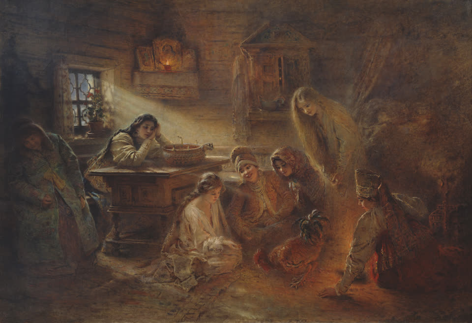 A dim Russian peasant room at night in an oil painting: a shaft of pale winter light falls from a small window, a lamp burns before icons in the corner, and six young women in headscarves and embroidered dress are gathered on the floor around a cockerel pecking at grain scattered on a rug, while another leans on a table beside a shallow bowl and a candle.