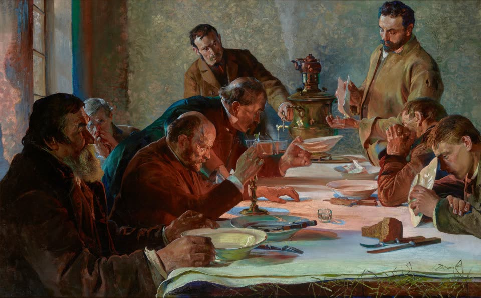 Jacek Malczewski, Christmas Eve in Siberia, 1892: ten men round a long table under a white cloth in a bare room, a brass samovar at the far end, empty white bowls and a lit candle in front of them and a dark loaf with a knife laid beside it. At the head of the table a standing man holds up a thin pale wafer to break; of the men seated, several have their faces in their hands. Wisps of hay show from under the tablecloth at the near corner.